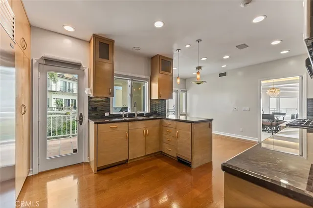 a kitchen with stainless steel appliances granite countertop a sink and a stove