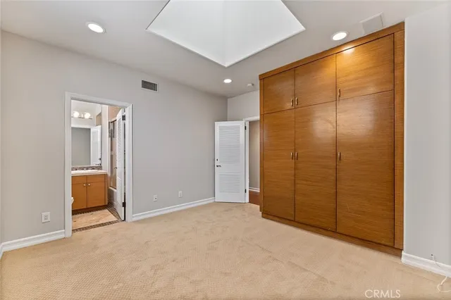 an empty room with closet and bathroom