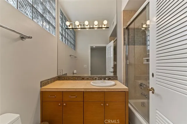 a bathroom with a sink mirror and a shower