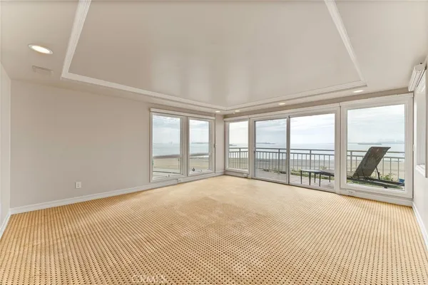 a view of an empty room with a window and a balcony