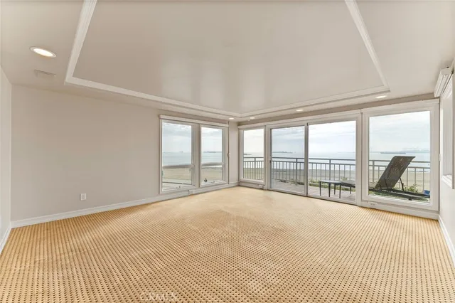 a view of an empty room with a window and a balcony