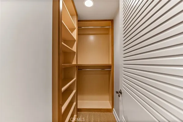 a view of a kitchen with kitchen island a large window a sink and a counter top space