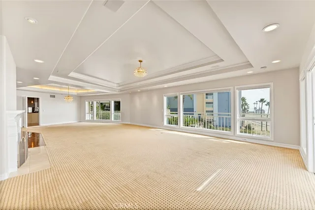 a big room with windows and chandelier
