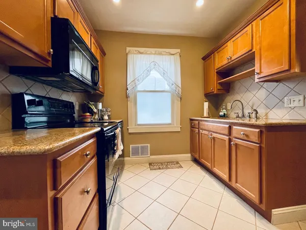 a kitchen with a refrigerator and cabinets