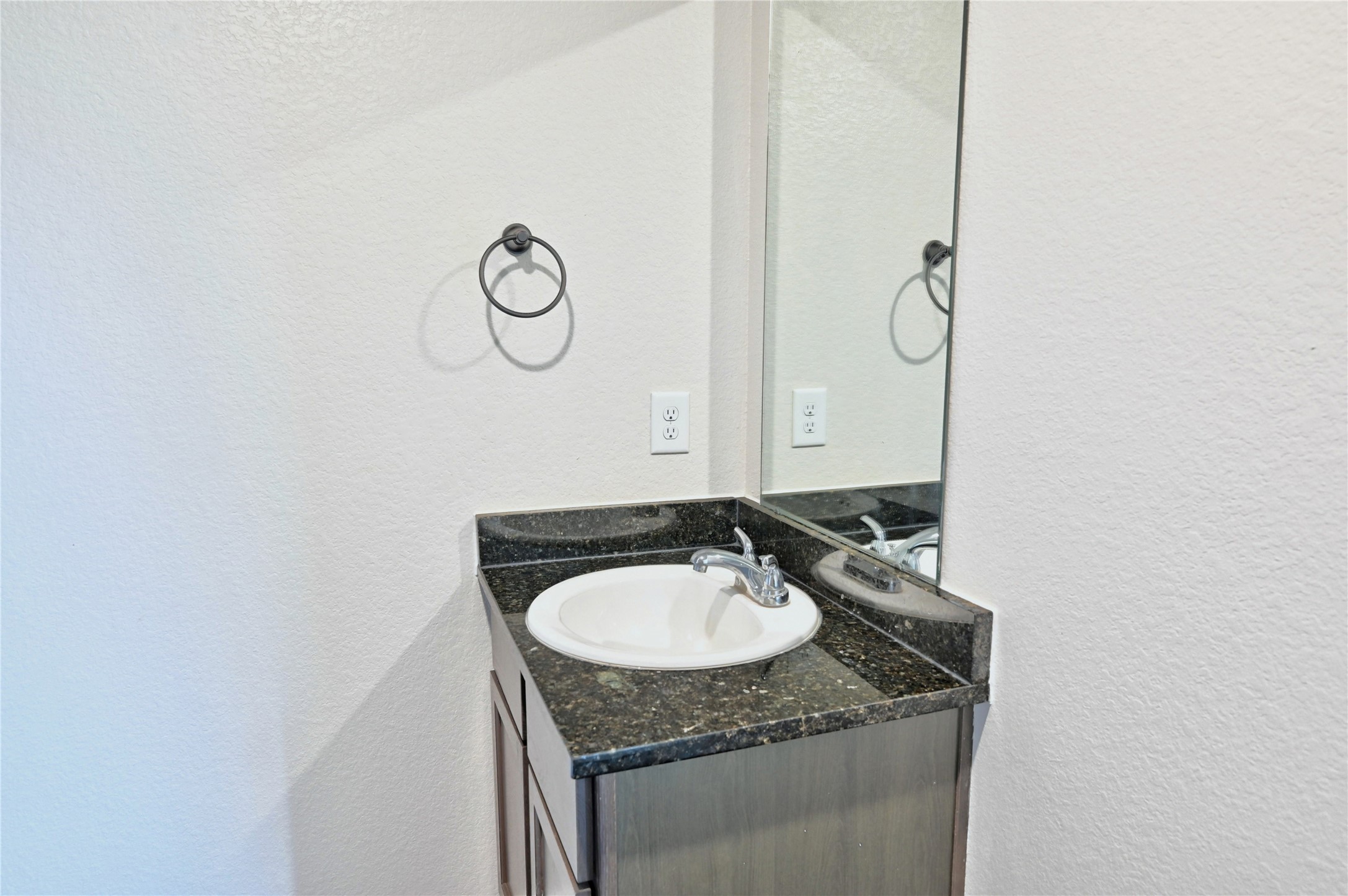 16623 Colleen Place Conroe, TX 77306 - Photo 18 of 44 a bathroom with a granite countertop sink and a mirror