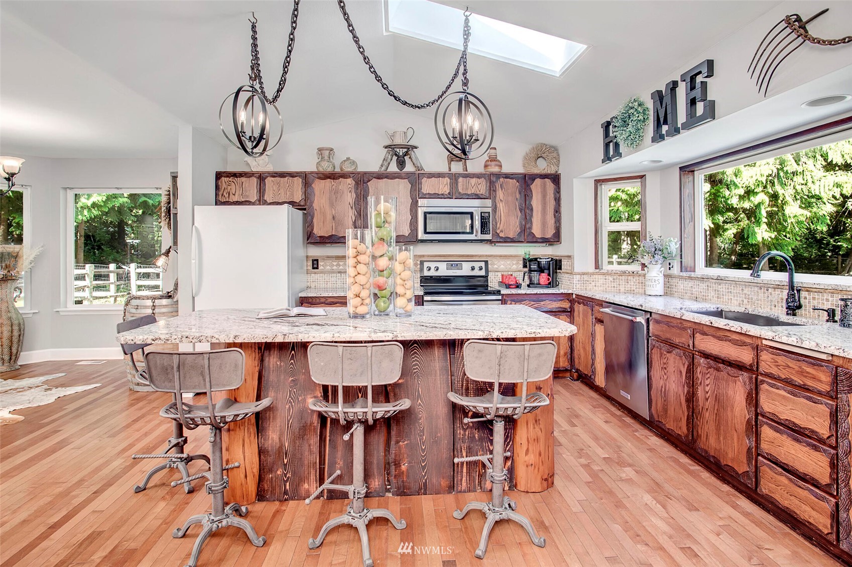12115 Gould Road Graham, WA 98338 - Photo 17 of 37 a dining table with chairs and wooden floor