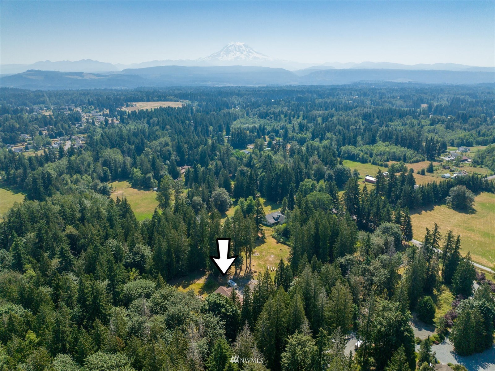 12115 Gould Road Graham, WA 98338 - Photo 25 of 37 an aerial view of a city with lots of residential buildings and mountain view in back