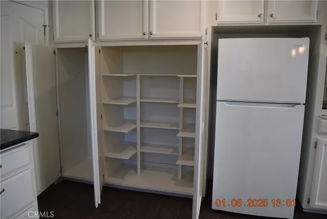 a white refrigerator freezer sitting inside of a kitchen