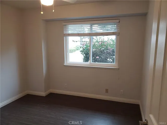 a view of a small space with wooden floor and a window