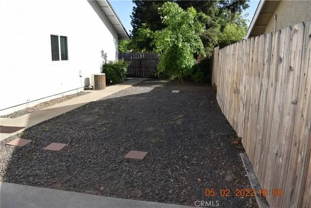 a view of a backyard with wooden fence