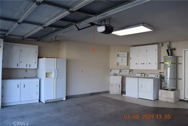a kitchen with refrigerator and cabinets