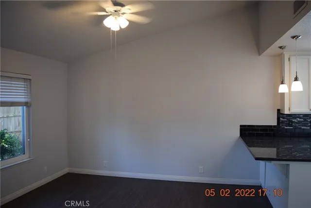 a kitchen with stainless steel appliances granite countertop a refrigerator a sink and a stove