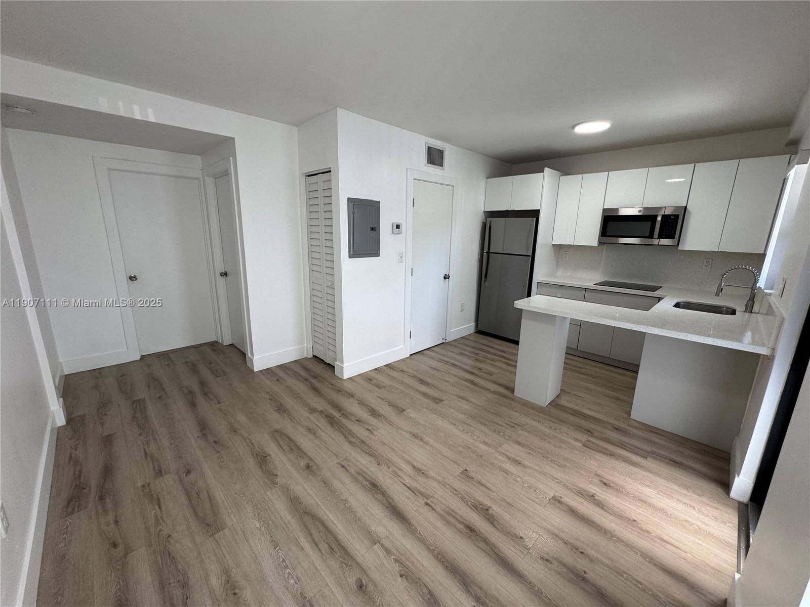 a kitchen with stainless steel appliances a refrigerator and a stove top oven