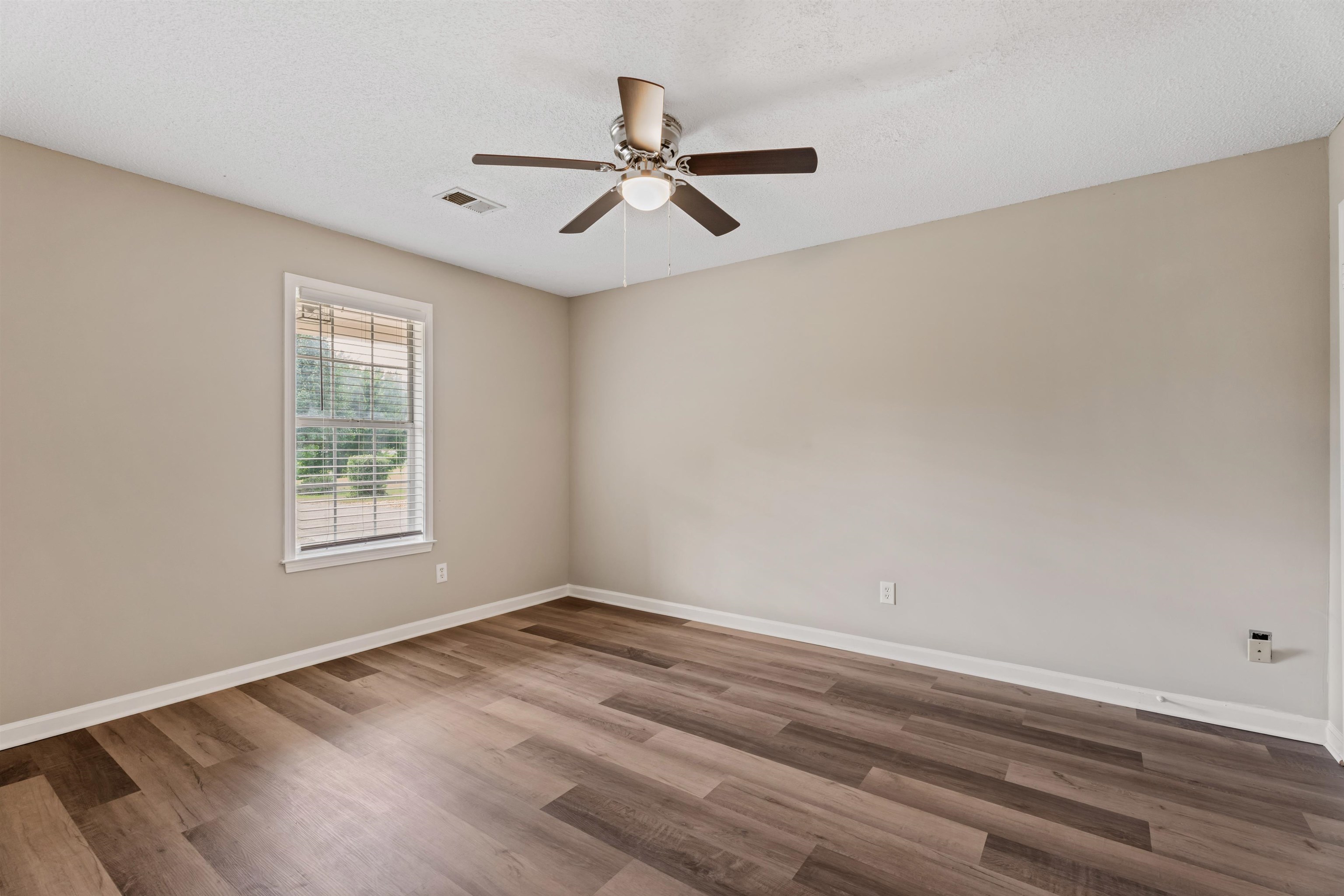 3282 Sunnyside Road Brighton, TN 38011 - Photo 15 of 24 Spare room with hardwood / wood-style flooring, a textured ceiling, and ceiling fan