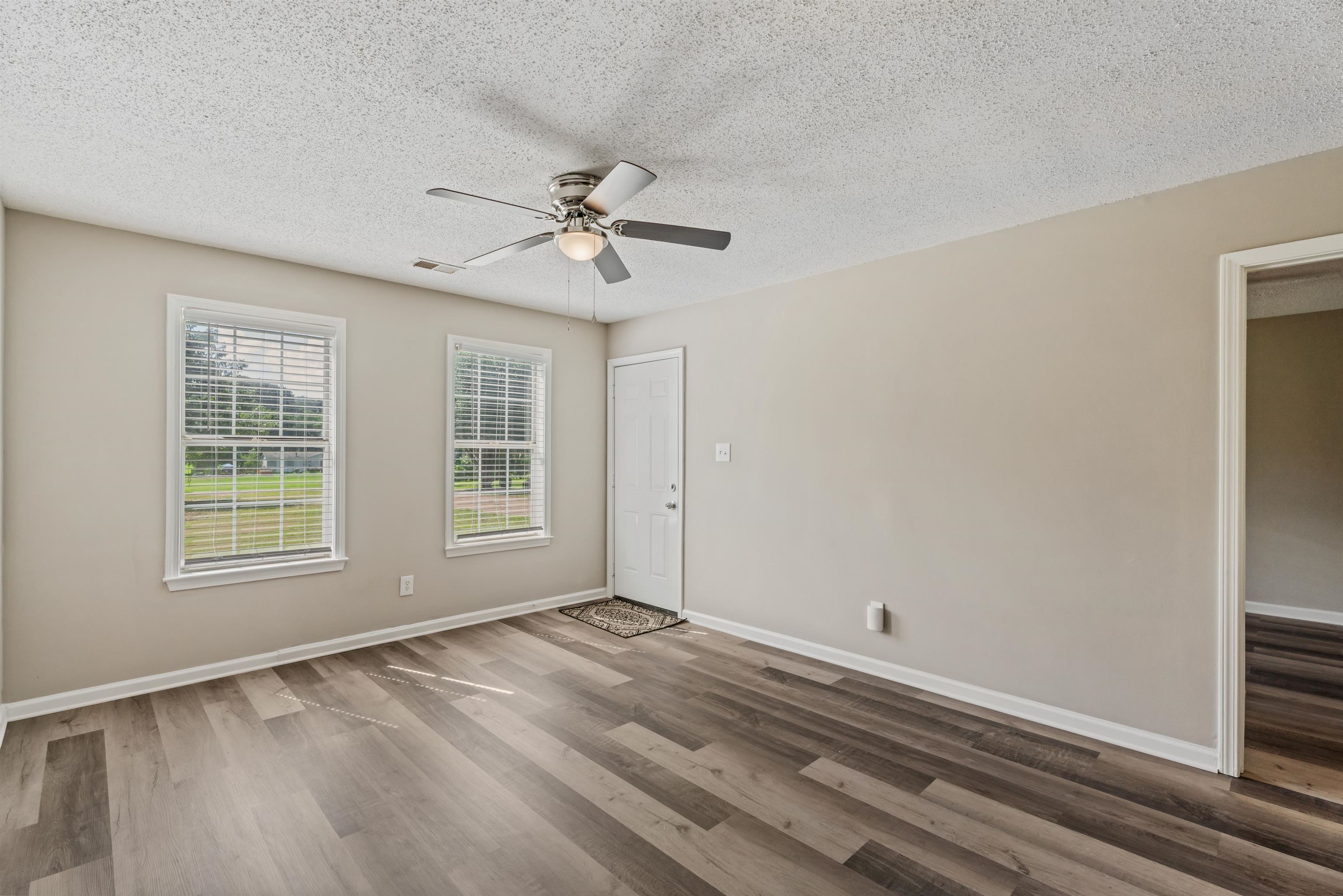 3282 Sunnyside Road Brighton, TN 38011 - Photo 4 of 24 Unfurnished room featuring a textured ceiling, wood-type flooring, and ceiling fan