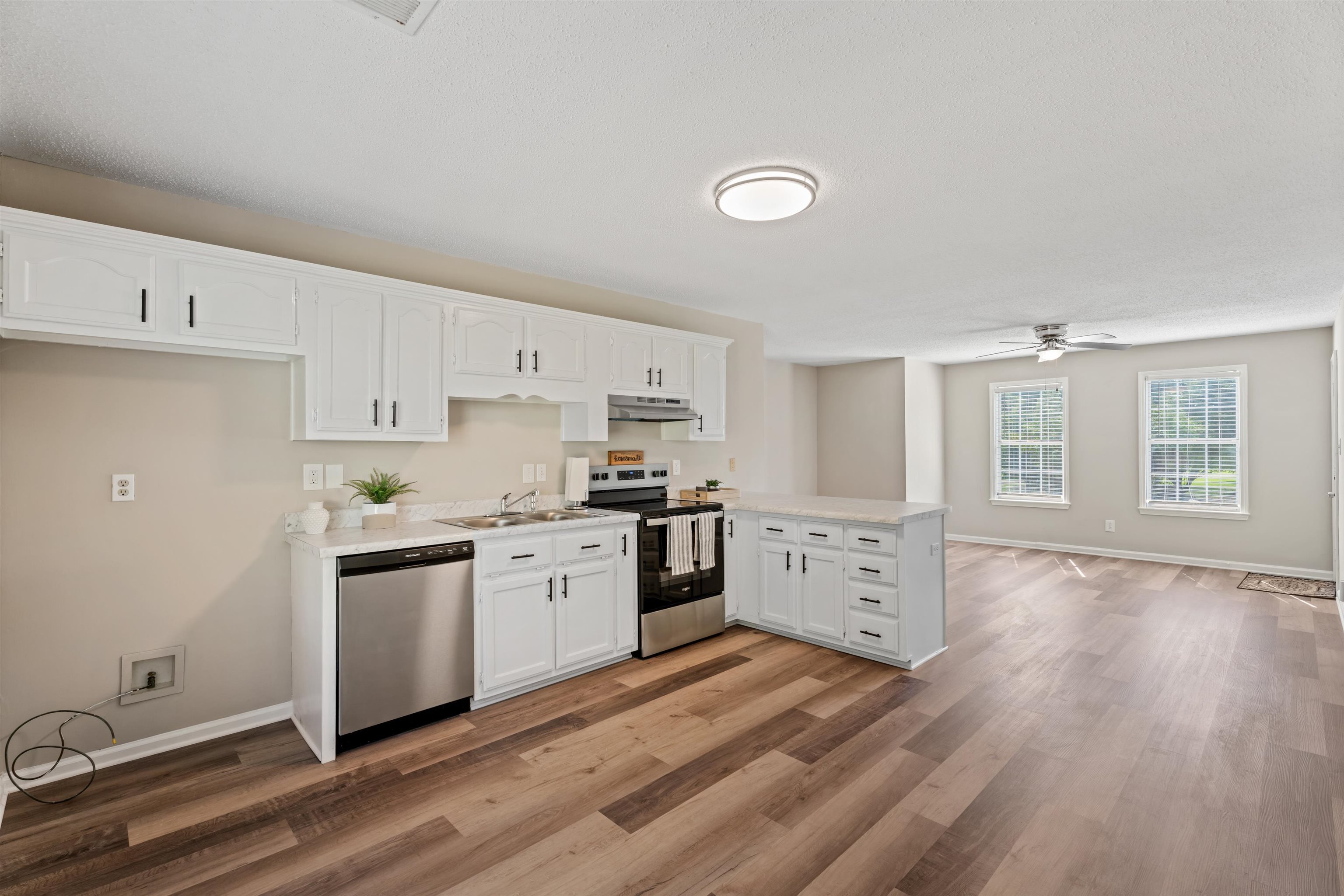 3282 Sunnyside Road Brighton, TN 38011 - Photo 6 of 24 Kitchen with white cabinetry, ceiling fan, sink, light hardwood / wood-style floors, and appliances with stainless steel finishes
