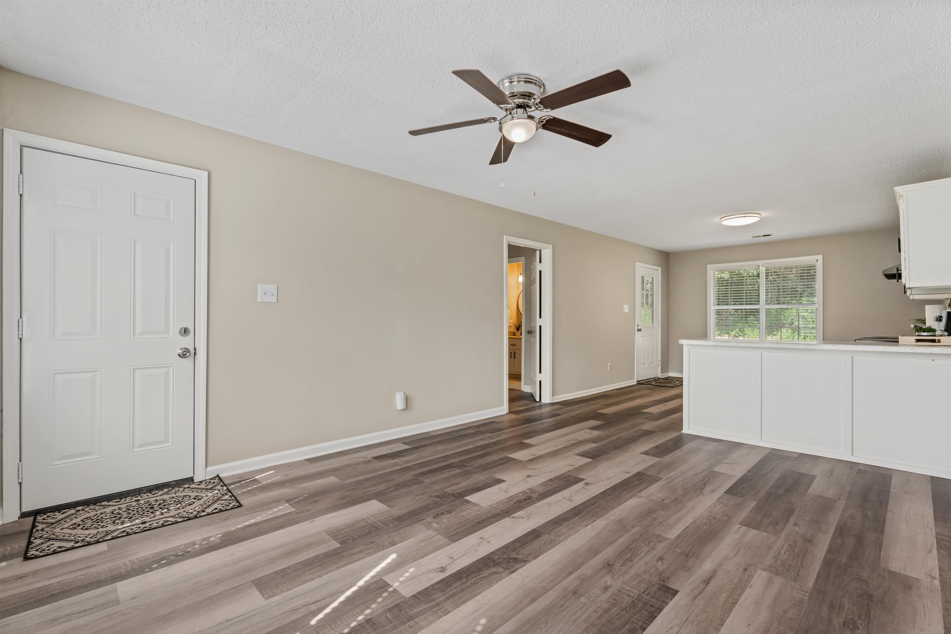 3282 Sunnyside Road Brighton, TN 38011 - Photo 8 of 24 Unfurnished living room featuring a textured ceiling, wood-type flooring, and ceiling fan