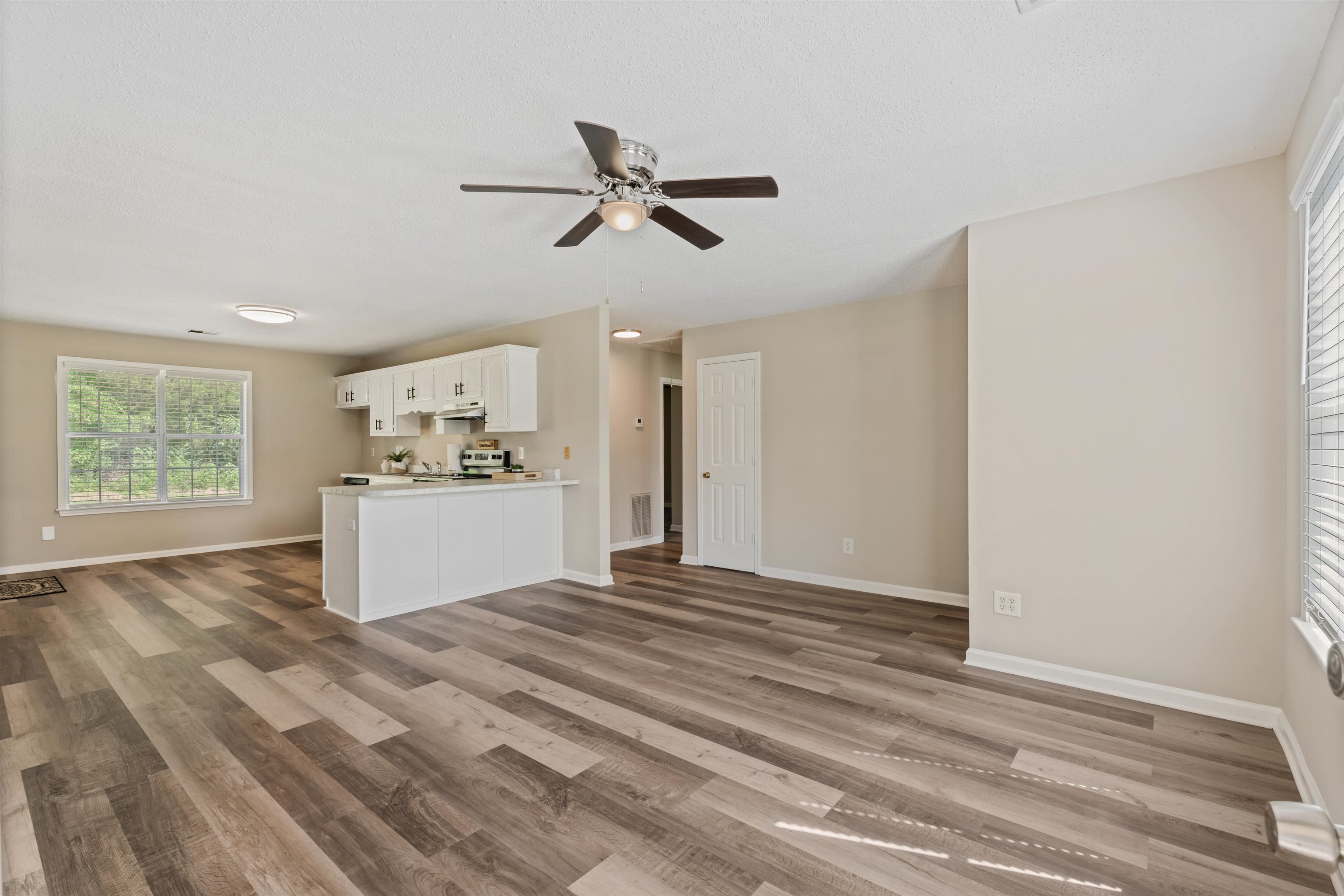 3282 Sunnyside Road Brighton, TN 38011 - Photo 9 of 24 Unfurnished living room featuring ceiling fan and hardwood / wood-style flooring