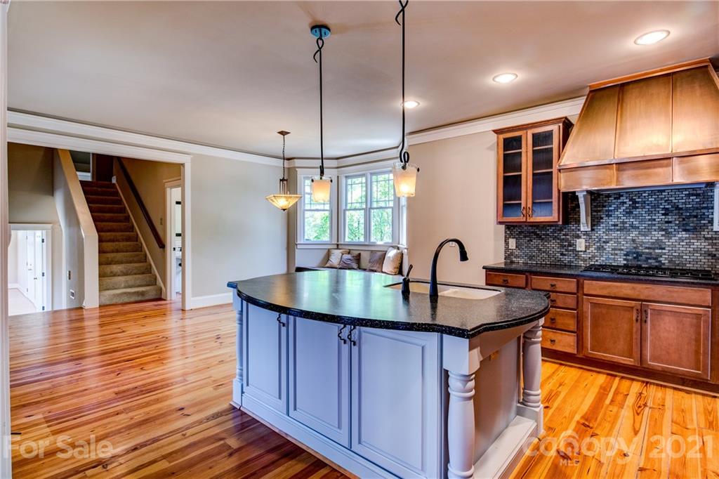 797 Shady Grove Crossing Fort Mill, SC 29708 - Photo 12 of 35 a kitchen with stainless steel appliances granite countertop a sink a stove and wooden floors