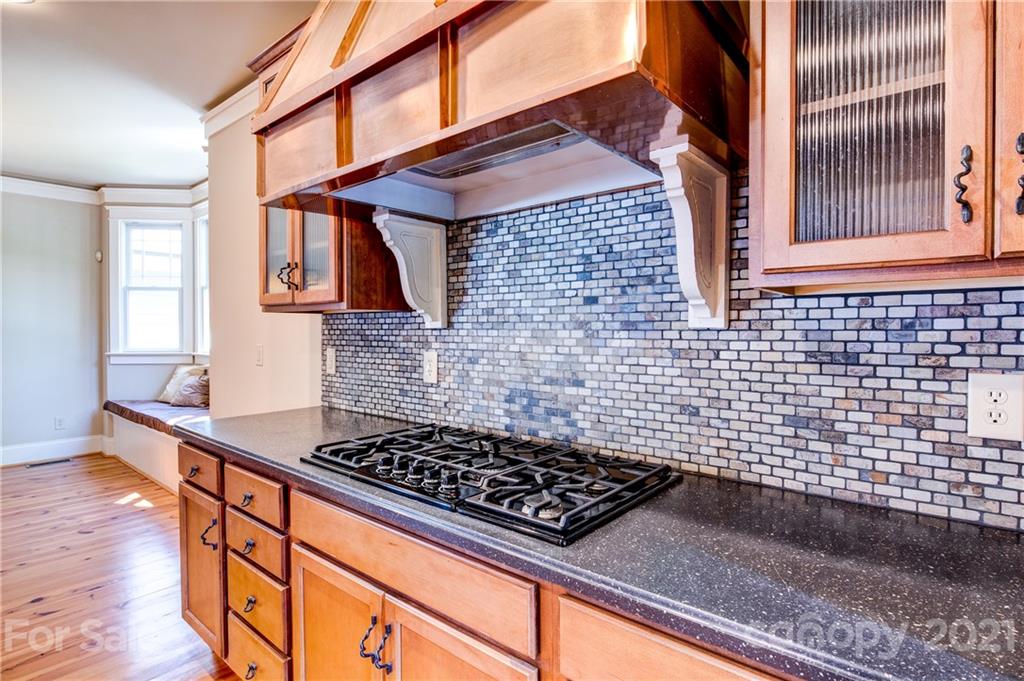 797 Shady Grove Crossing Fort Mill, SC 29708 - Photo 13 of 35 a kitchen with a stove a sink and wooden floor