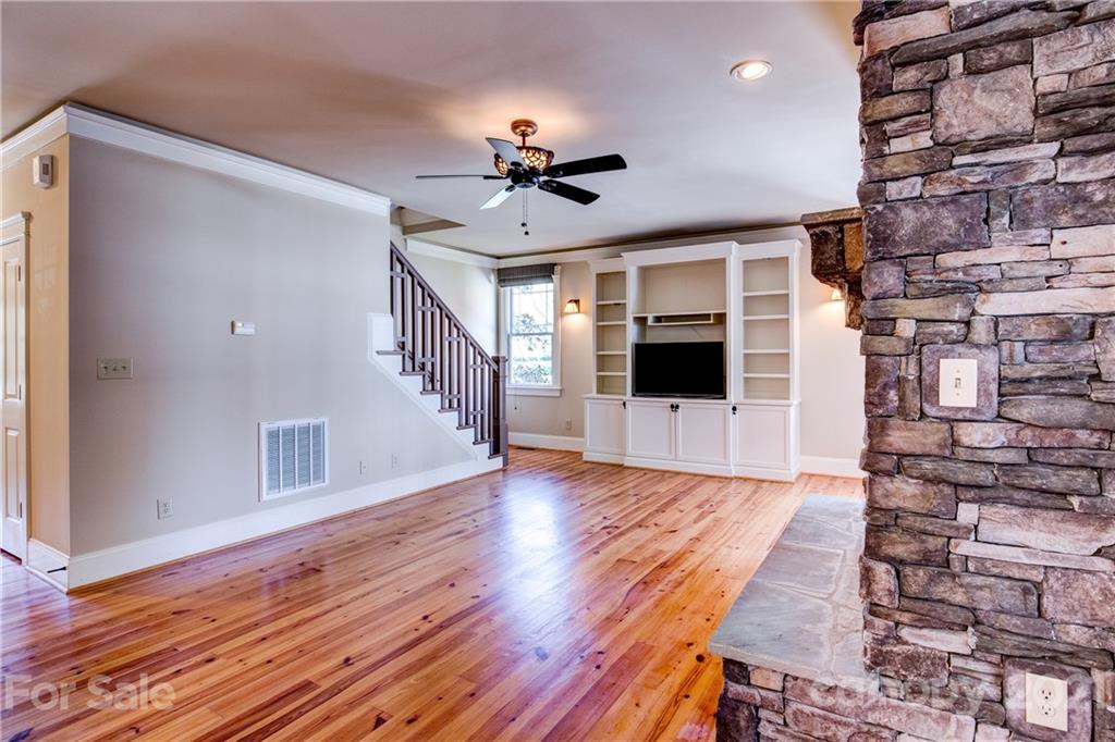 797 Shady Grove Crossing Fort Mill, SC 29708 - Photo 9 of 35 a view of a livingroom with wooden floor and a ceiling fan