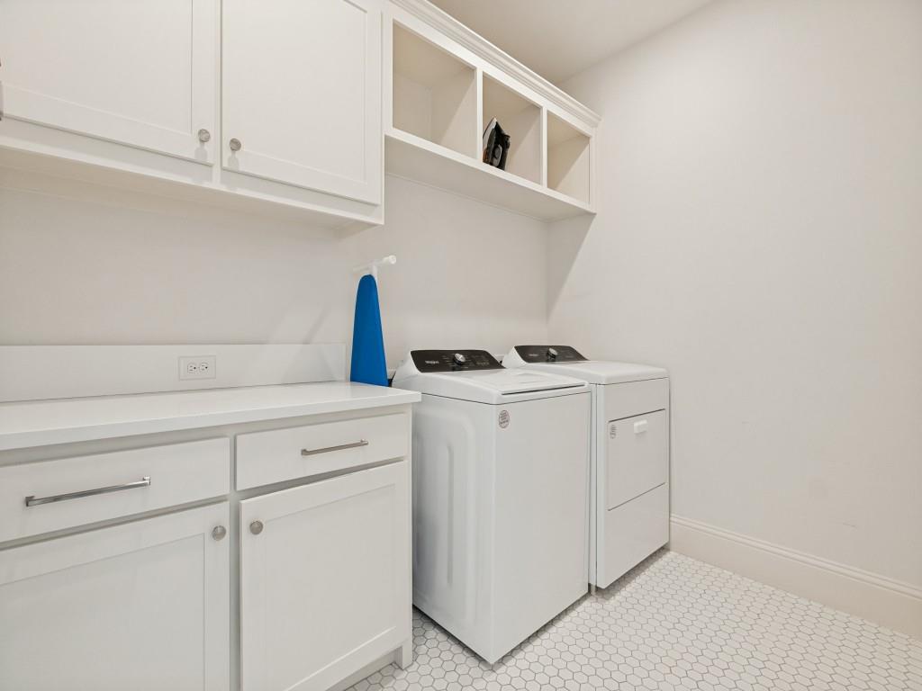 732 West 7th Street Dallas, TX 75208 - Photo 17 of 25 Dedicated utility space featuring white cabinetry with brushed nickel hardware, open shelving, a white countertop, and hexagonal floor tiling