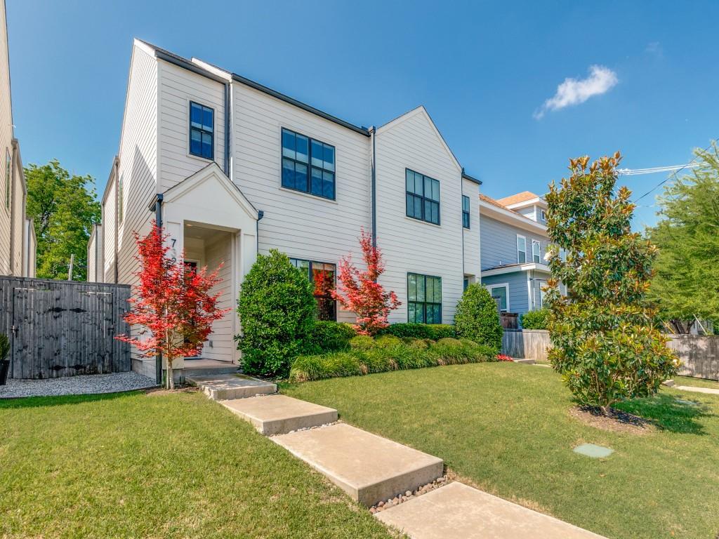 732 West 7th Street Dallas, TX 75208 - Photo 2 of 25 Contemporary white siding exterior featuring a covered entry, dark-framed windows, a meticulously maintained lawn, and mature landscaping