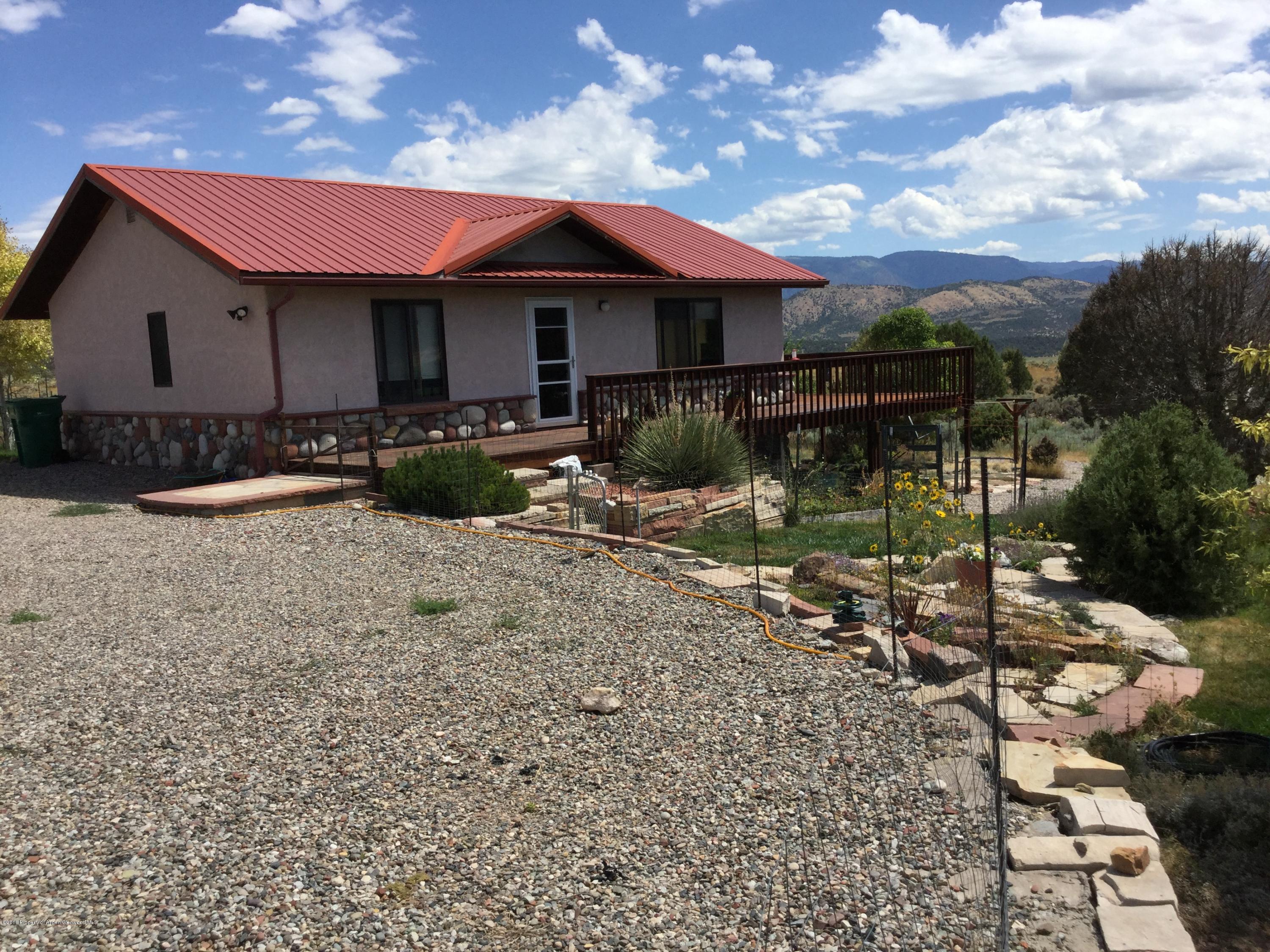 4112 County Road 226 Rifle, CO 81650 - Photo 1 of 34 a front view of a house with garden