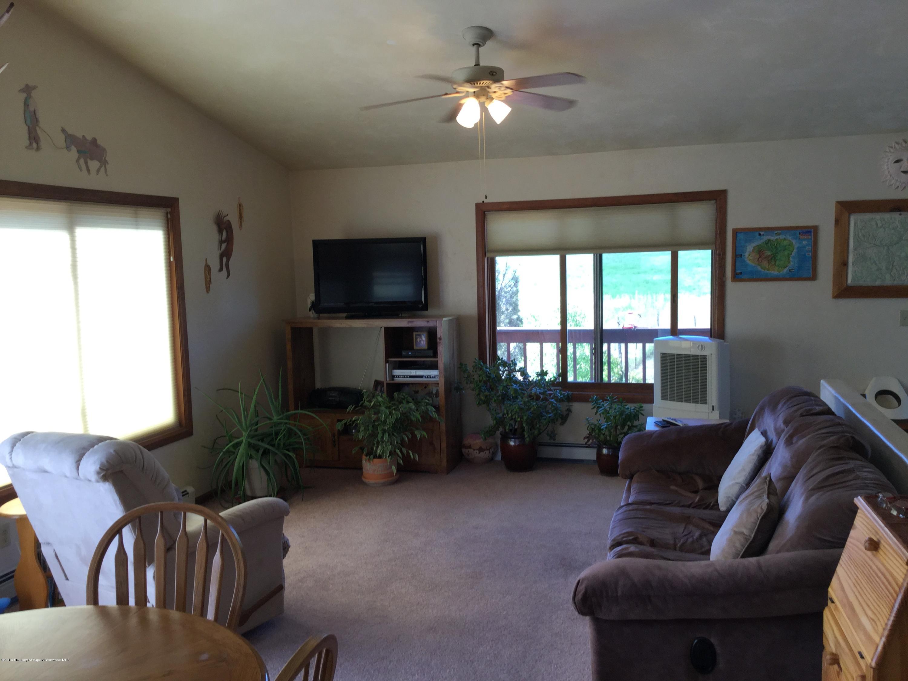 4112 County Road 226 Rifle, CO 81650 - Photo 5 of 34 a living room with furniture and a flat screen tv