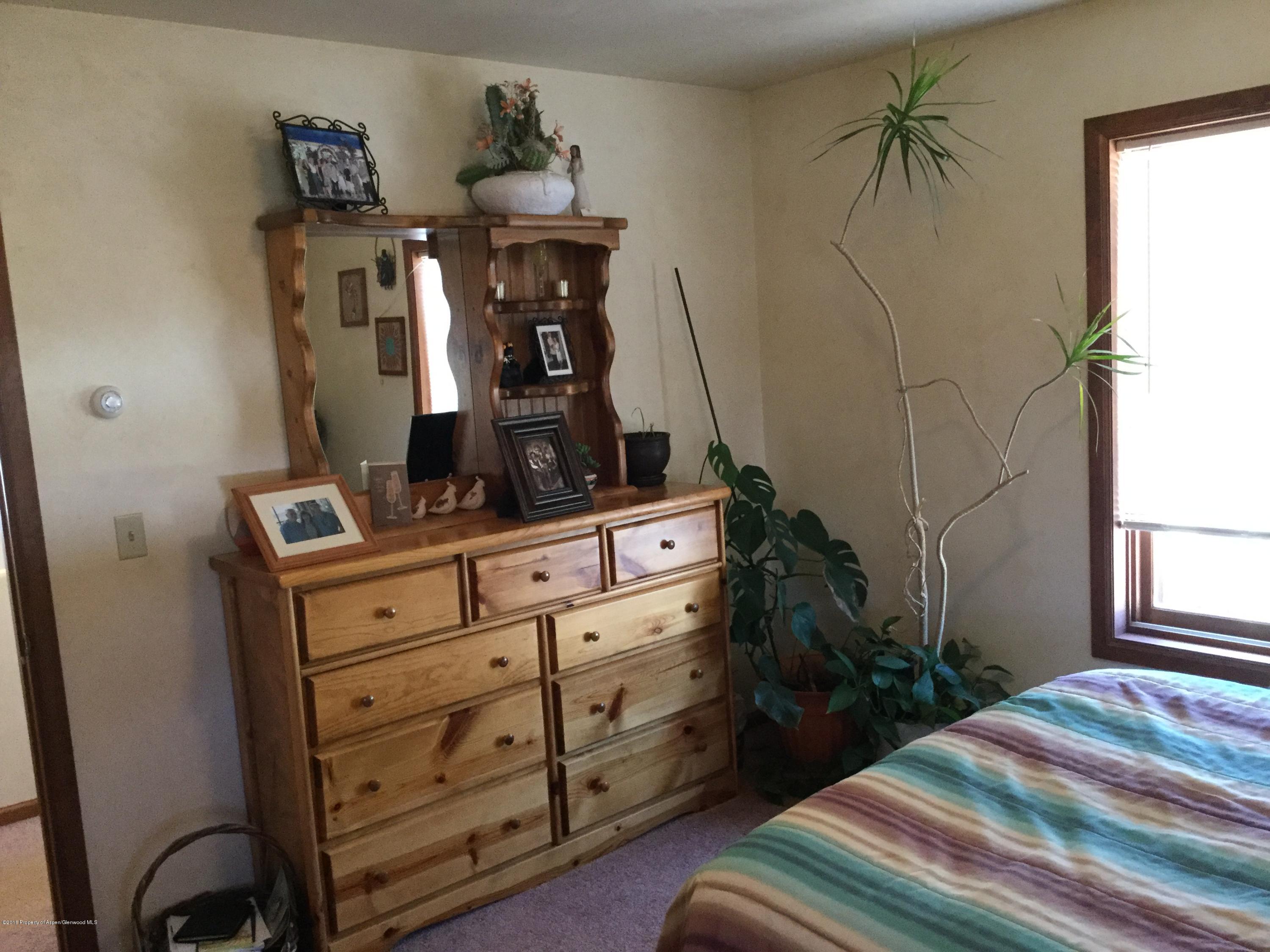 4112 County Road 226 Rifle, CO 81650 - Photo 10 of 34 a bedroom with a bed and a dresser