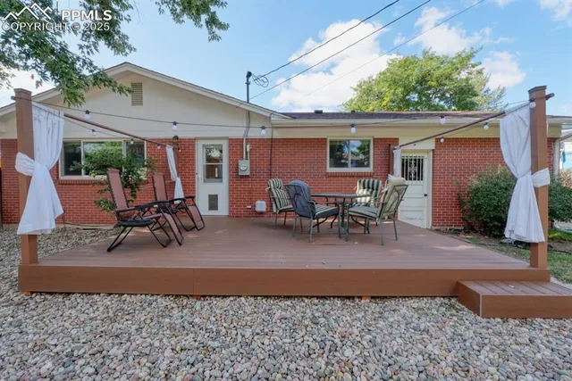 a view of a patio with a table and chairs