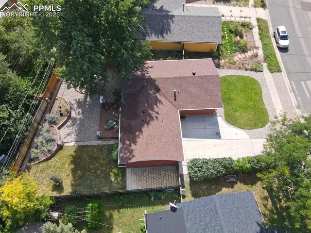 a view of a house with a yard and potted plants