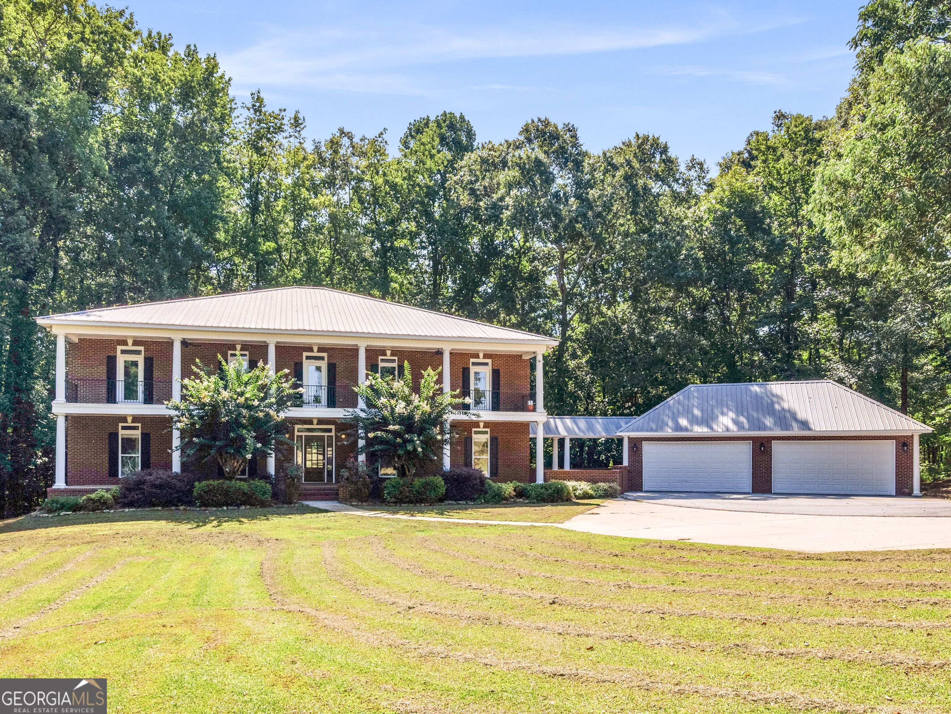 a front view of a house with a yard patio and swimming pool