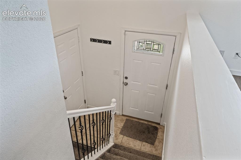 125 Diamond E Road Fountain, CO 80817 - Photo 7 of 43 a view of a hallway with wooden floor and door