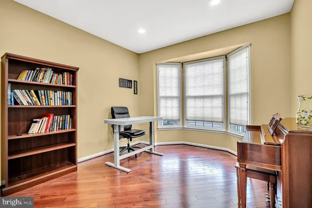 a living room with furniture and a book shelf
