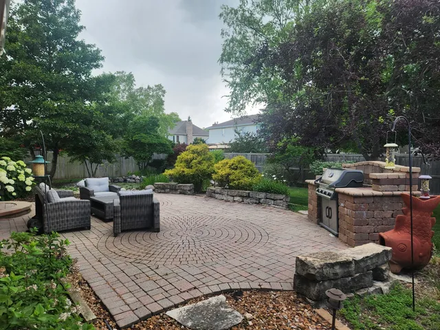 a view of a backyard with sitting area