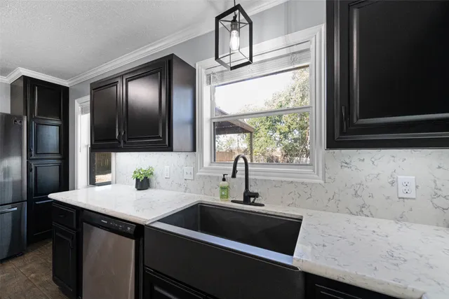 a kitchen with a sink and a refrigerator