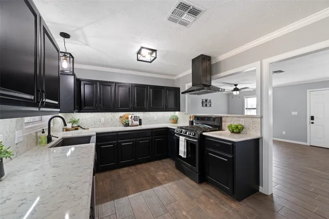 a kitchen with stainless steel appliances granite countertop a sink and stove