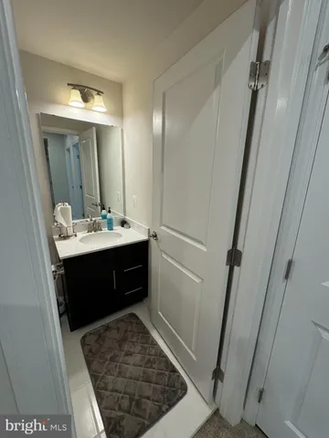 a bathroom with a sink vanity and a mirror