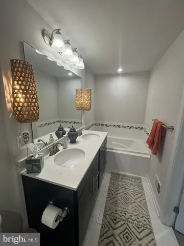 a bathroom with a sink double vanity and a mirror