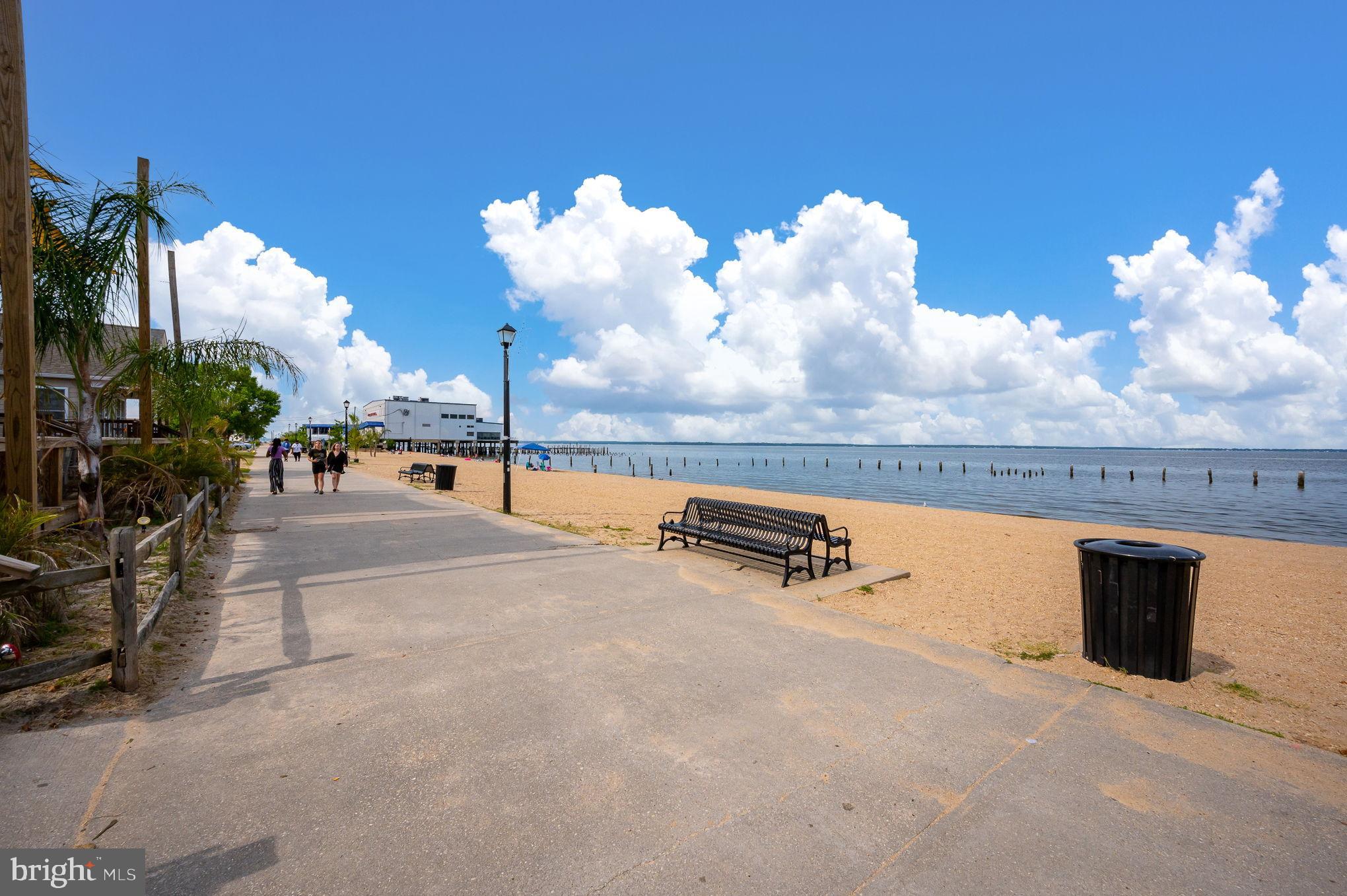 312 9th Street Colonial Beach, VA 22443 - Photo 47 of 62 Scenic waterfront path under bright skies.