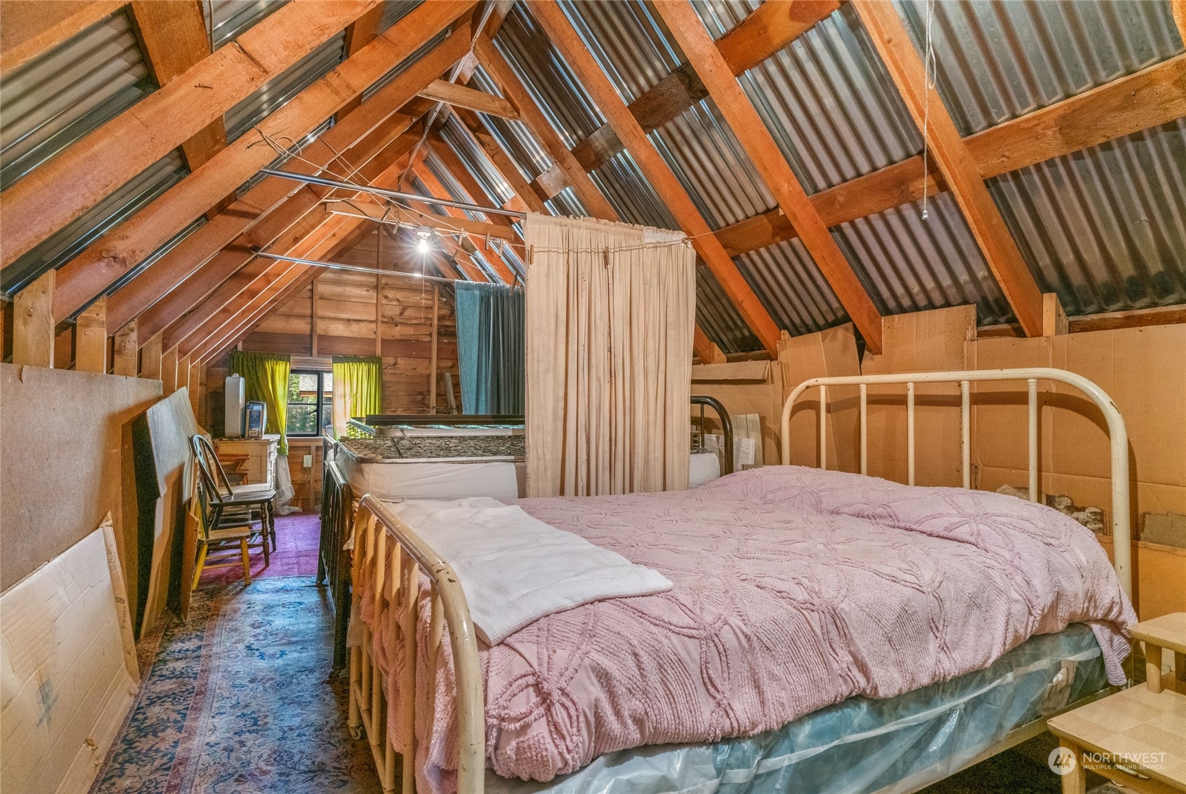 15231 Cedar Brae Road Leavenworth, WA 98826 - Photo 16 of 24 a bed room with a bed and a chair