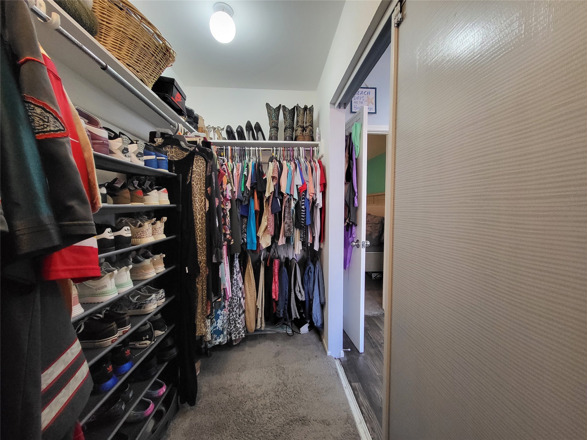 9406 Walnut Glen Drive Houston, TX 77064 - Photo 15 of 20 a view of walk in closet with clothes and shoes