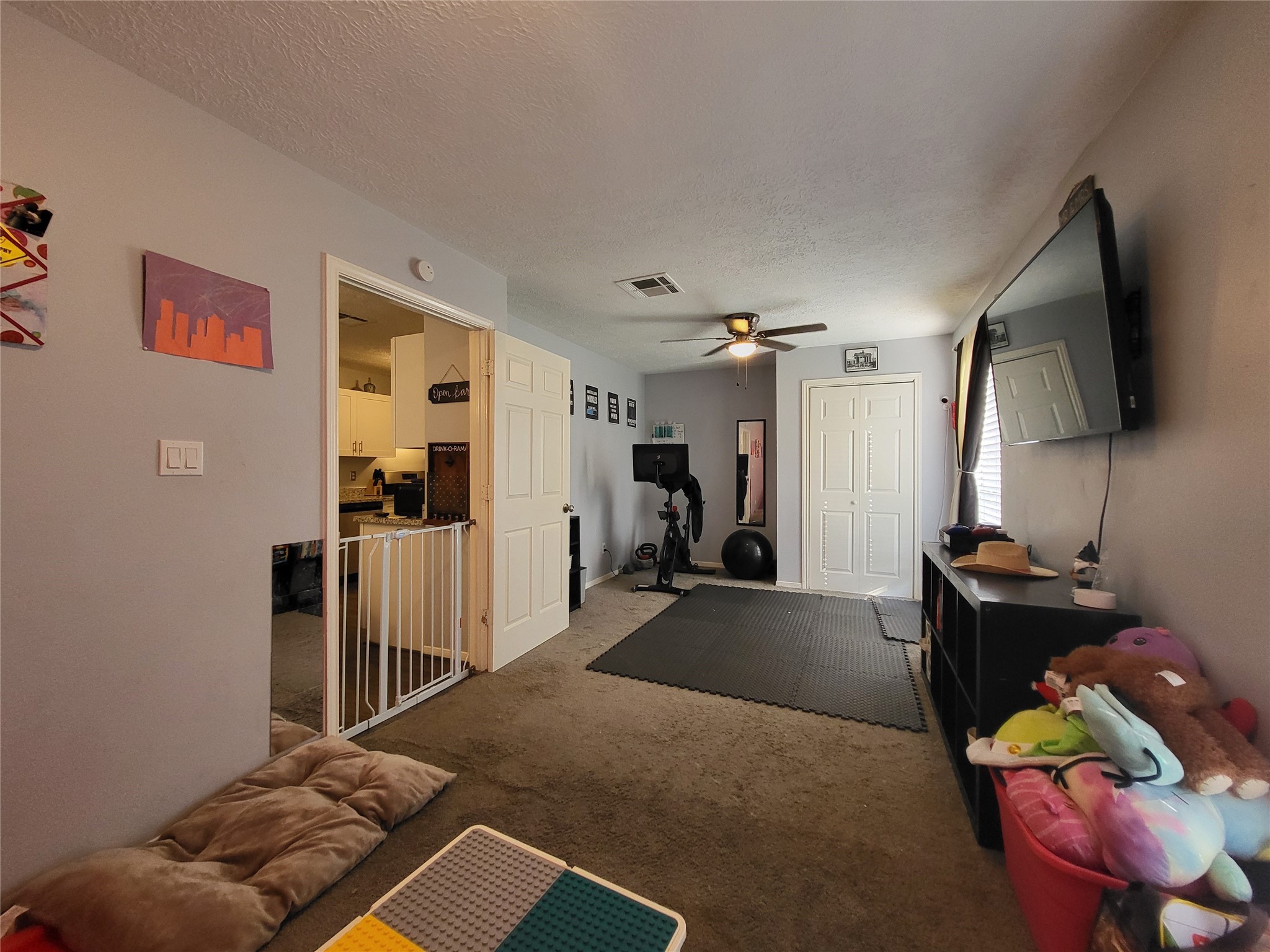 9406 Walnut Glen Drive Houston, TX 77064 - Photo 8 of 20 a bedroom with furniture and a flat screen tv