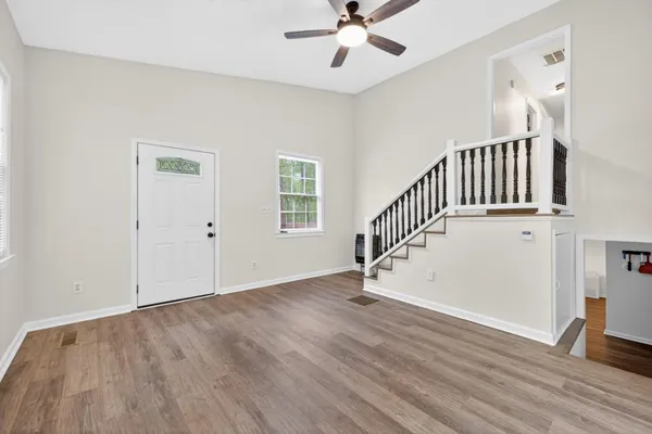 a view of an entryway with wooden floor