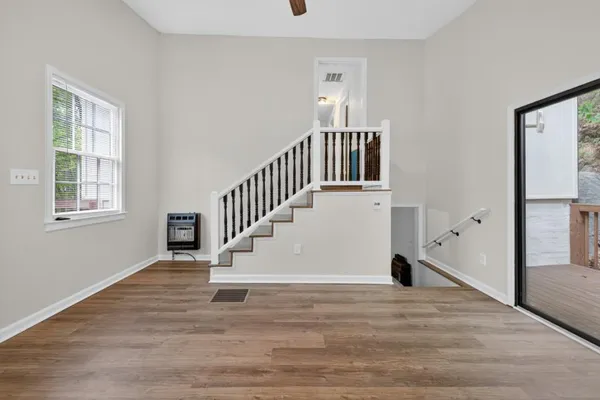 a view of entryway and hall with wooden floor