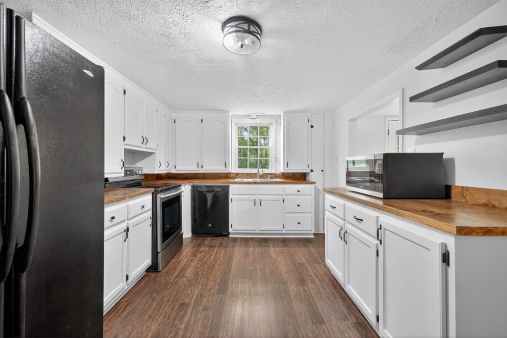 256 Robin Hood Ln N East Fairmount, GA 30139 - Photo 15 of 52 a kitchen with white cabinets and appliances