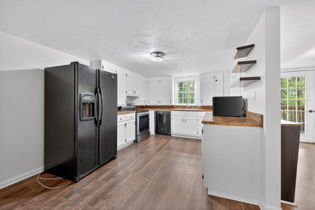 256 Robin Hood Ln N East Fairmount, GA 30139 - Photo 16 of 52 a kitchen with stainless steel appliances a refrigerator and a stove top oven