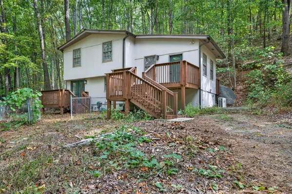 a view of a house with a yard and sitting area