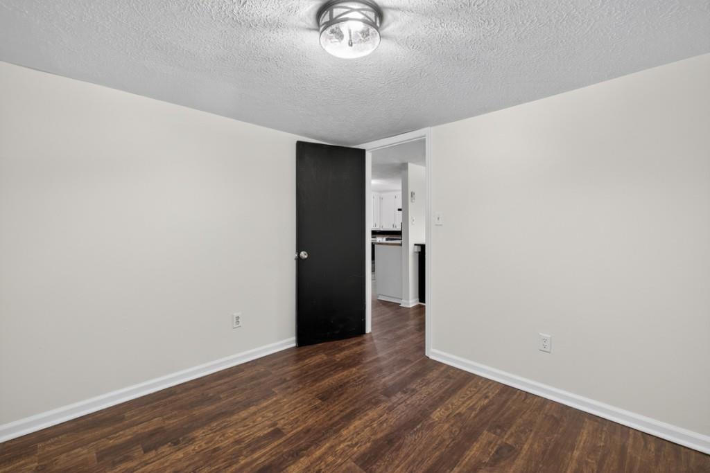 256 Robin Hood Ln N East Fairmount, GA 30139 - Photo 25 of 52 a view of empty room with wooden floor and window